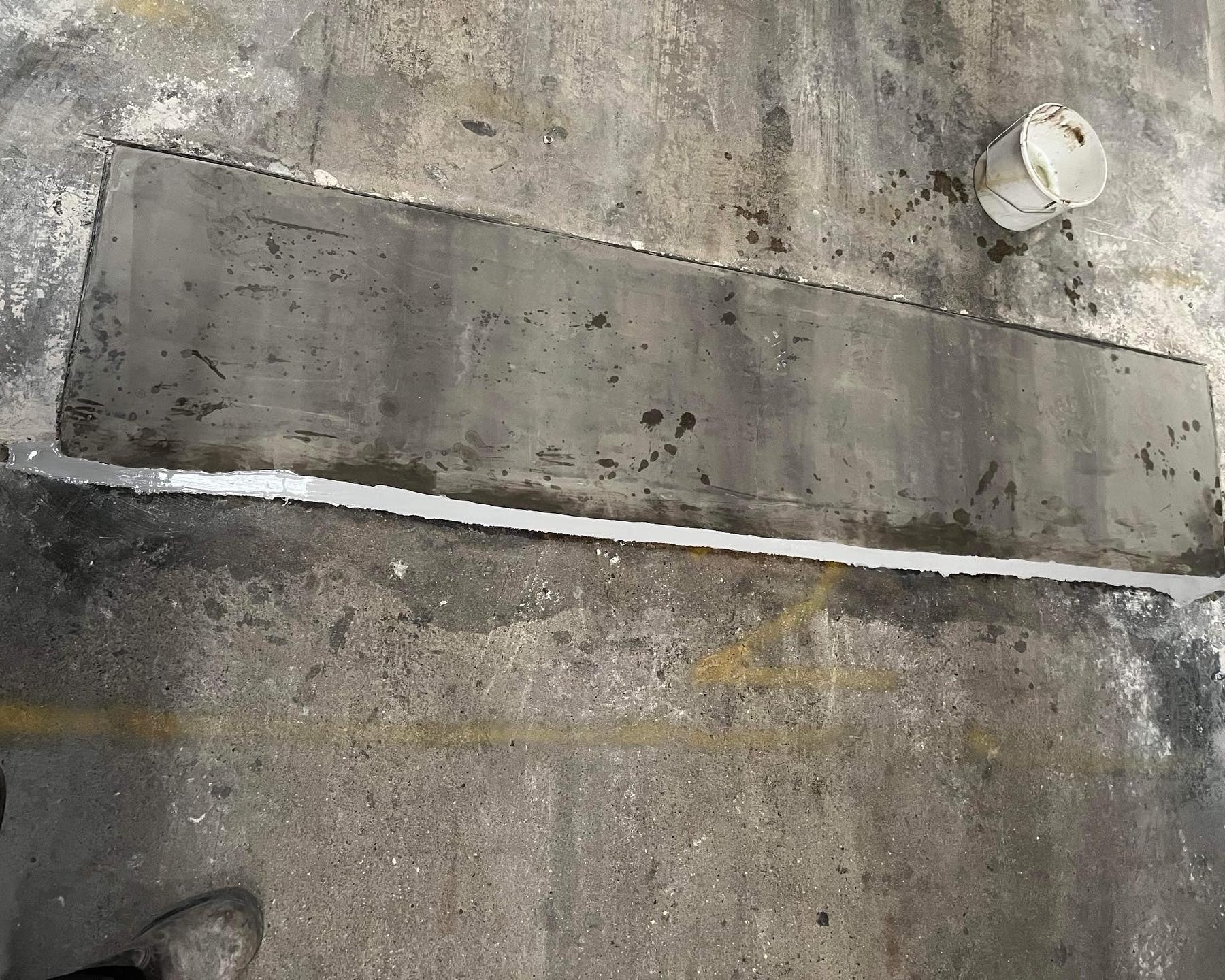 Close up of a repaired mastic joint between panels on a commercial building.